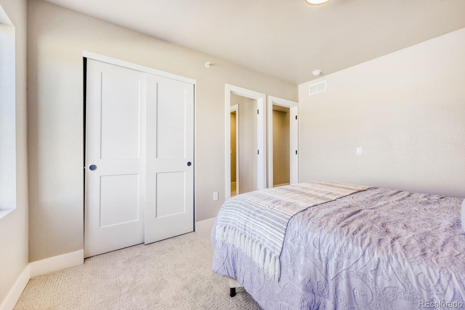 9195 Pierce Street, Unit 7 Westminster, CO 80021 - Photo 15 of 25 a bedroom with a bed and a closet