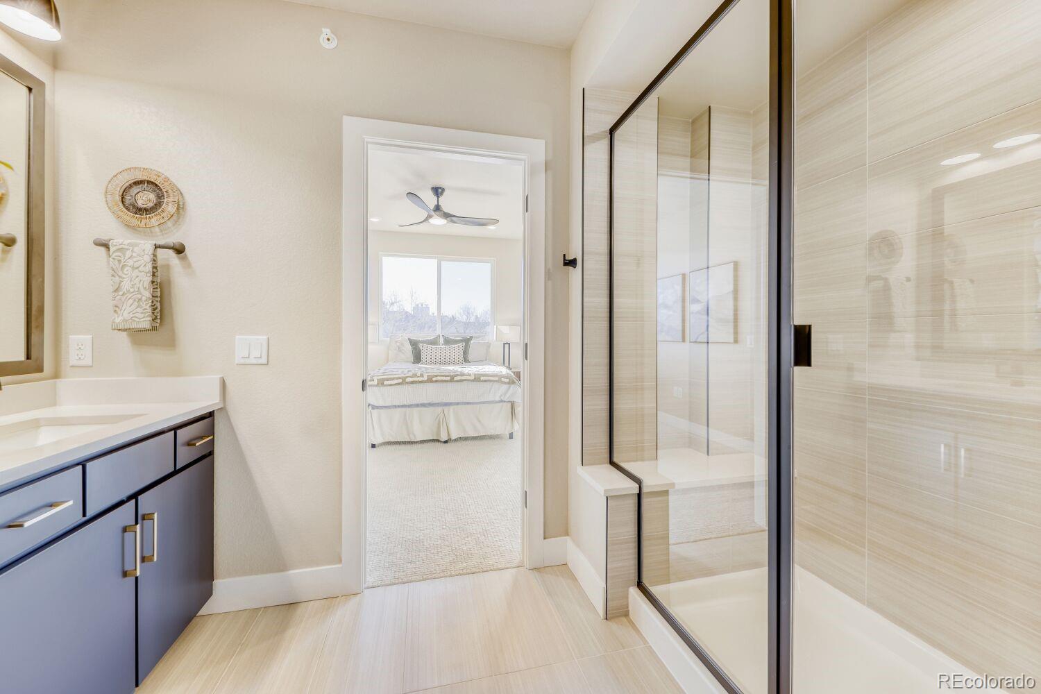 9195 Pierce Street, Unit 7 Westminster, CO 80021 - Photo 23 of 25 a bathroom with a tub shower sink and mirror
