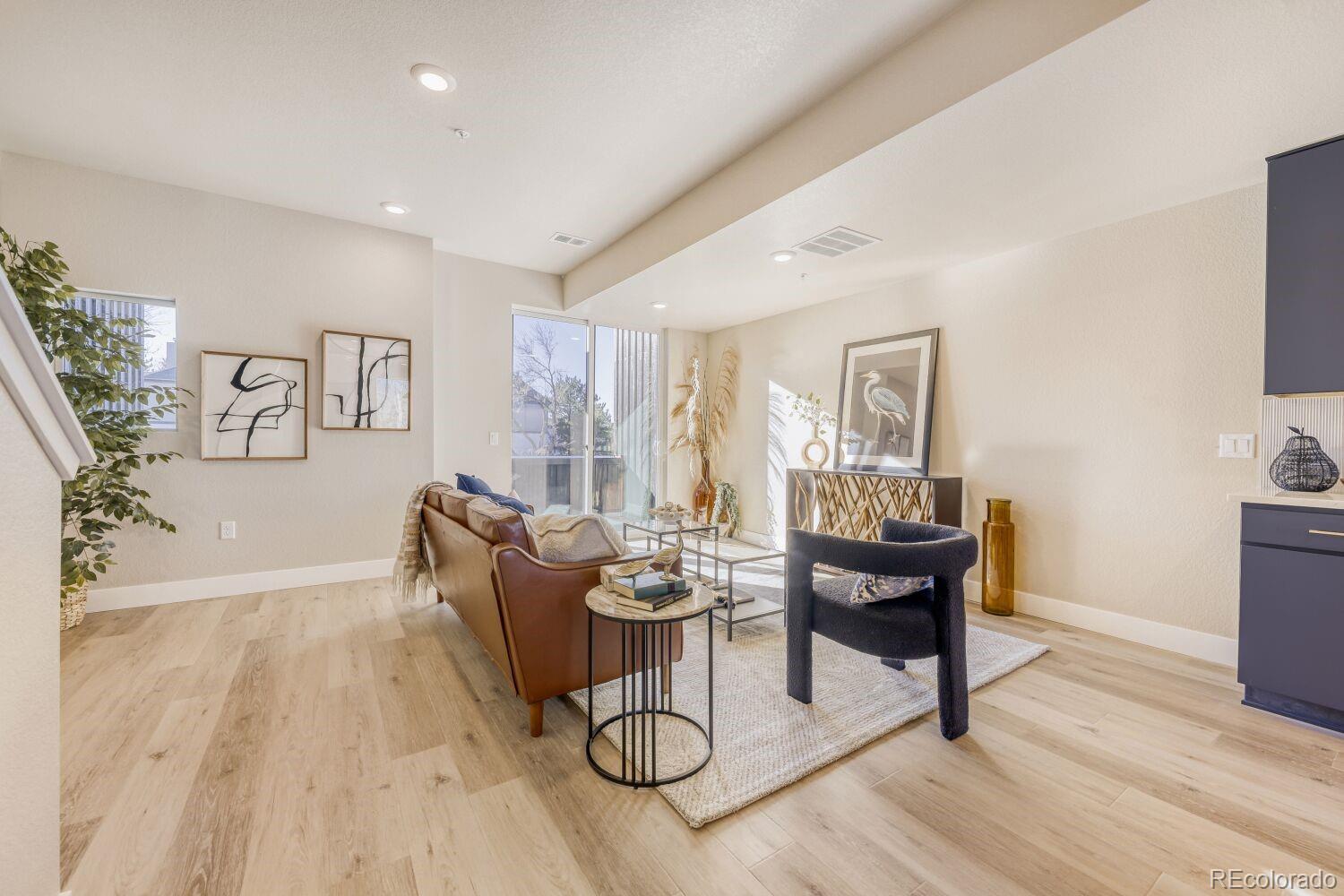 9195 Pierce Street, Unit 7 Westminster, CO 80021 - Photo 3 of 25 a living room with furniture a dining table and a potted plant