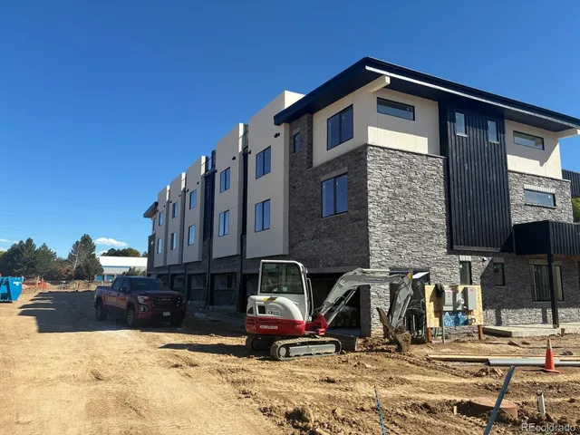 a front view of a house with yard and parking space