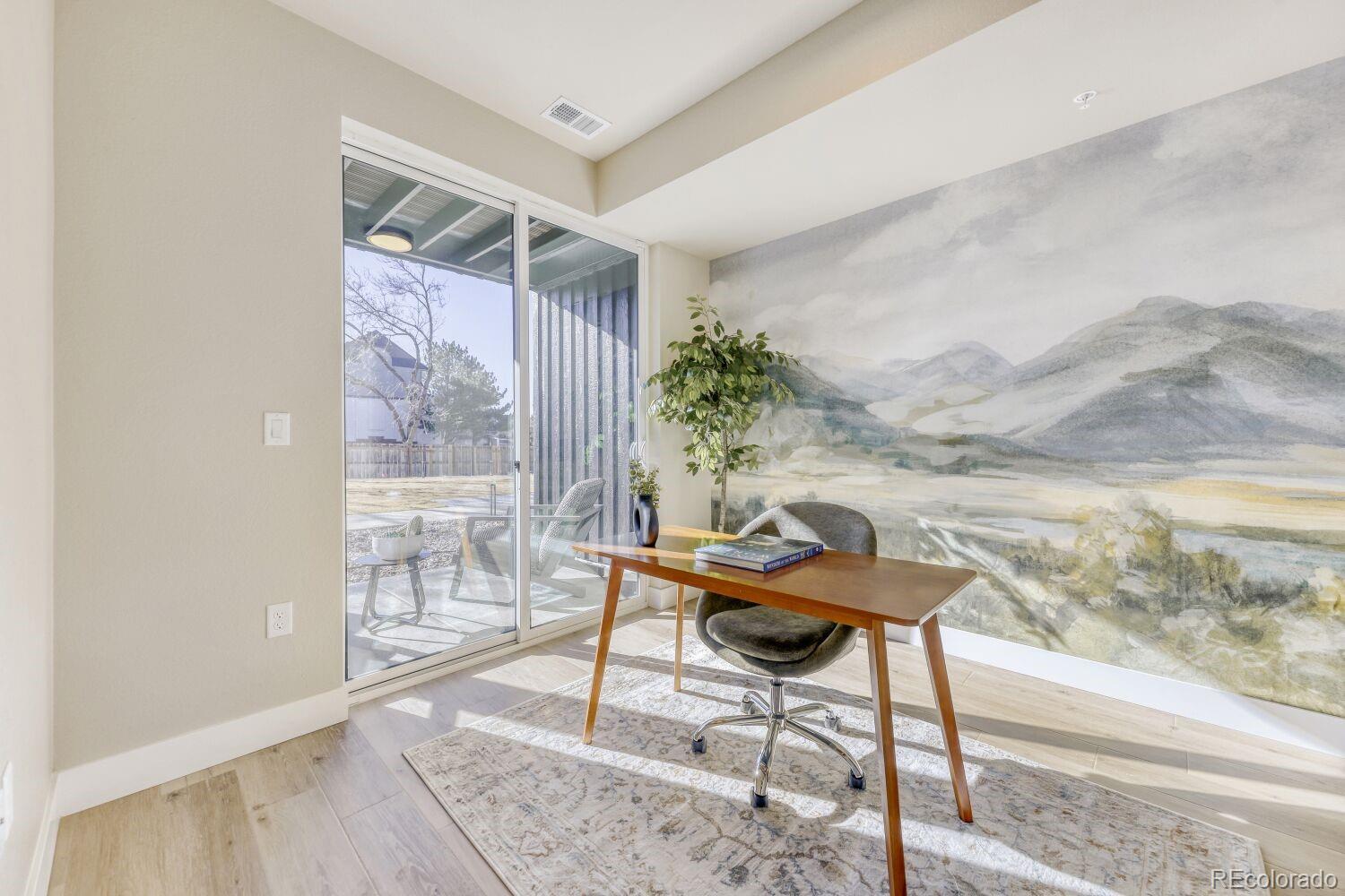 9195 Pierce Street, Unit 7 Westminster, CO 80021 - Photo 9 of 25 a workspace with furniture and a gate