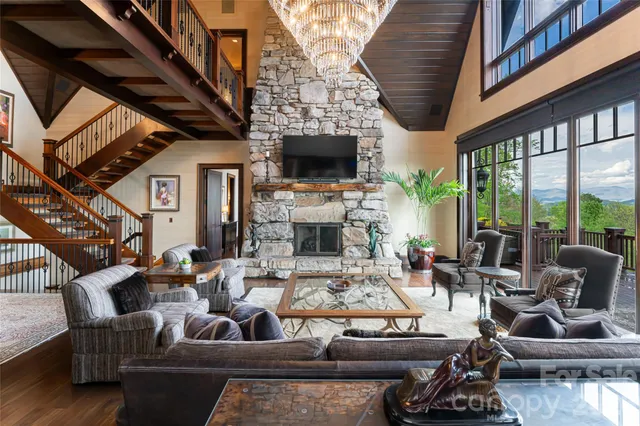 a kitchen with stainless steel appliances kitchen island granite countertop a stove a sink a dining table and chairs