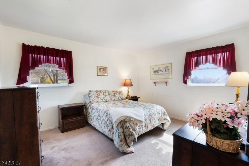 248 Perry Street Dover, NJ 07801 - Photo 15 of 24 a bedroom with a bed and a chandelier