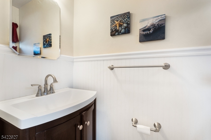 248 Perry Street Dover, NJ 07801 - Photo 17 of 24 a bathroom with a sink and a mirror