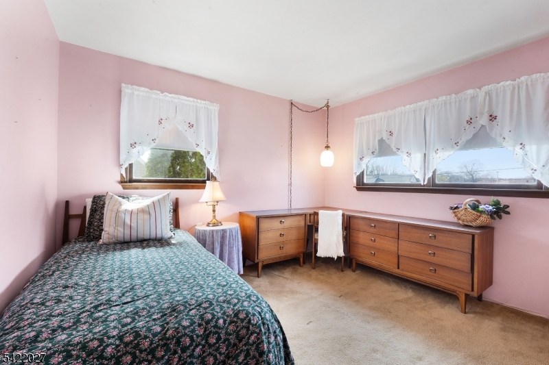 248 Perry Street Dover, NJ 07801 - Photo 19 of 24 a bedroom with a bed and a dresser