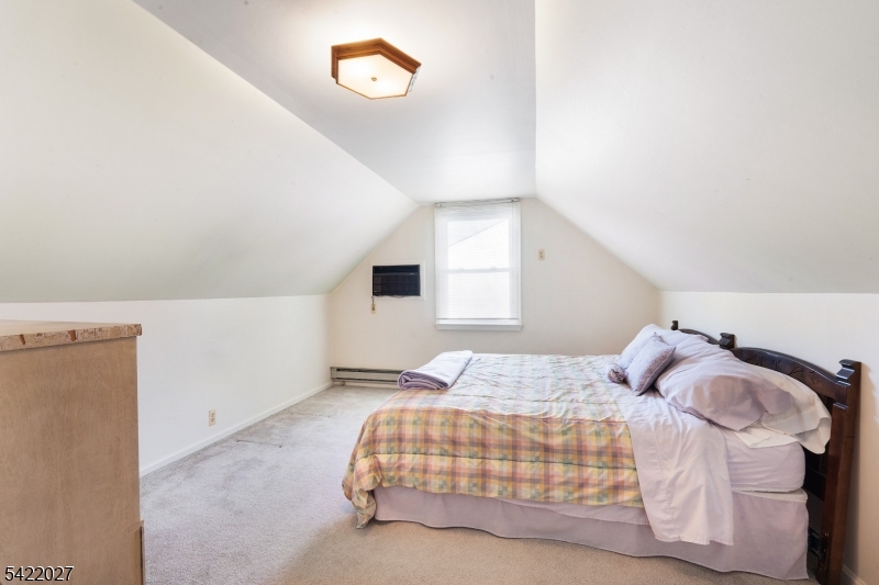 248 Perry Street Dover, NJ 07801 - Photo 20 of 24 a bedroom with a bed and a window