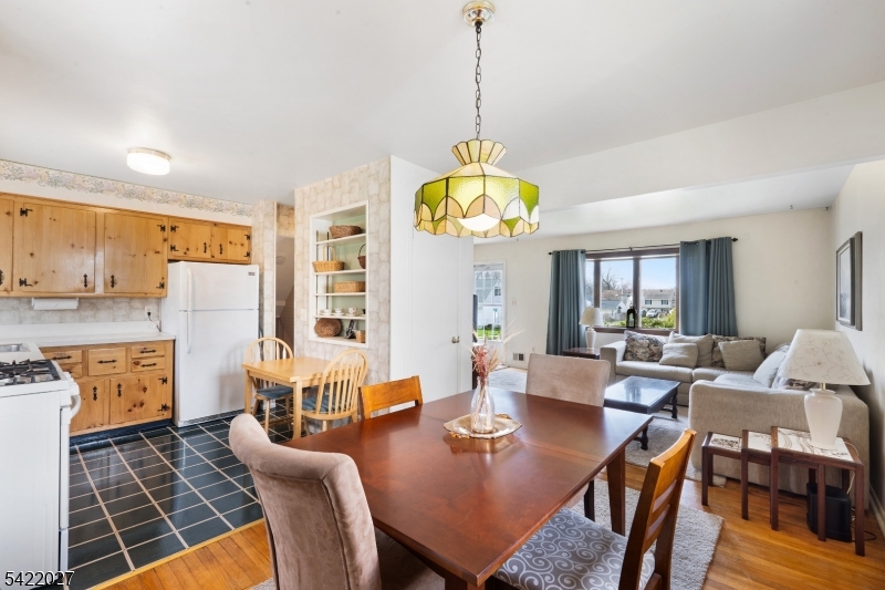 248 Perry Street Dover, NJ 07801 - Photo 8 of 24 a view of a dining room with furniture a chandelier and wooden floor