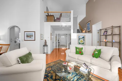 a living room with furniture and painting on the wall