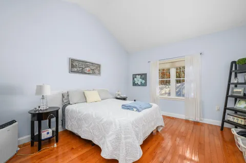 a bedroom with a bed and a book shelf