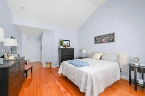 a spacious bedroom with a bed and a table in it