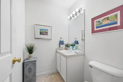 a bathroom with a sink a toilet and mirror