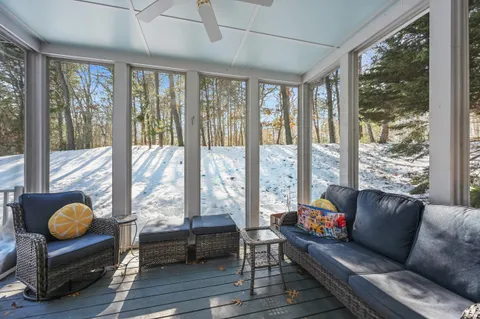 a living room with furniture and a floor to ceiling window