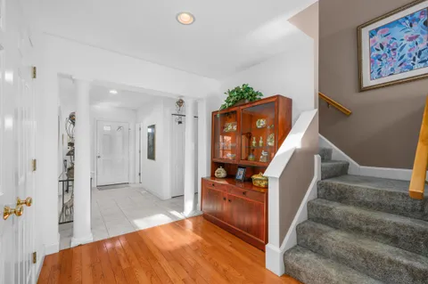 a view of a living room with furniture and a flat screen tv