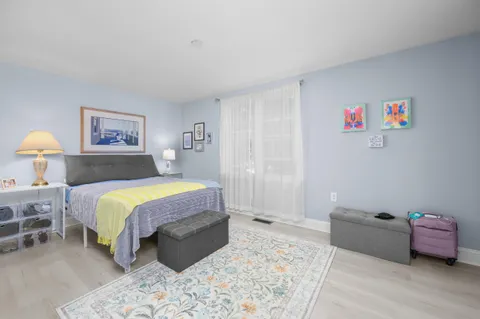 a spacious bedroom with a bed and a window