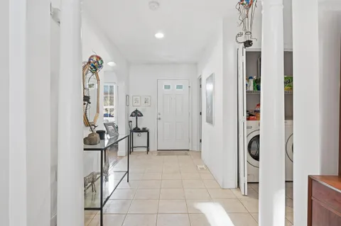 a view of a hallway with wooden floor and a livingroom view