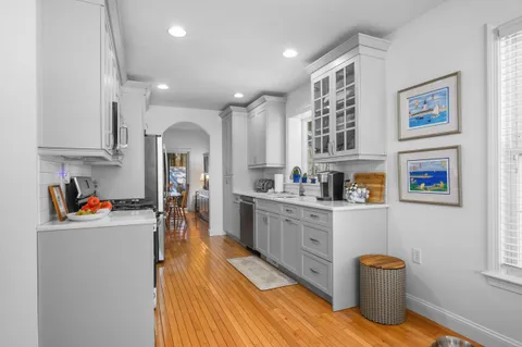 a kitchen with stainless steel appliances granite countertop a refrigerator and a sink