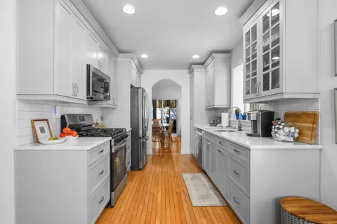 a kitchen with stainless steel appliances granite countertop a stove and a sink