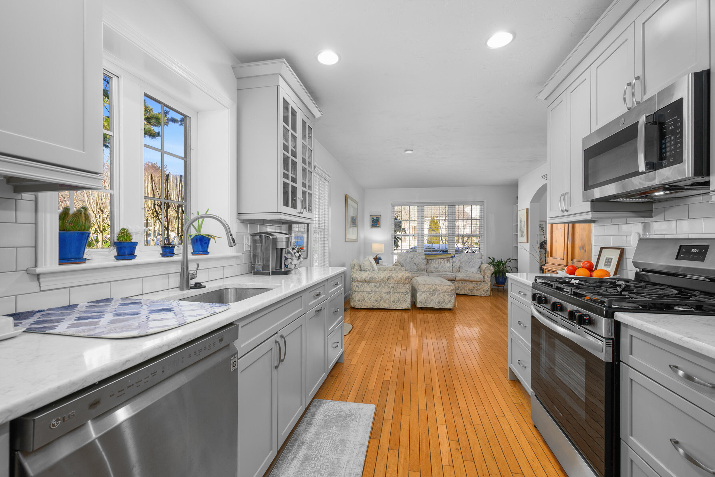 22 Stratford Ridge, Unit 22 Mashpee, MA 02649 - Photo 7 of 38 a large kitchen with stainless steel appliances a stove a sink and a microwave