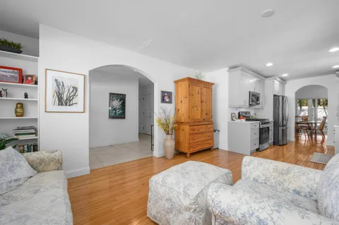 a bedroom with furniture and a kitchen