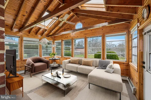 a living room with furniture and floor to ceiling windows