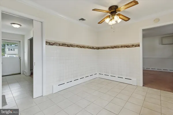 a view of a room with rack on the wall and a chandelier