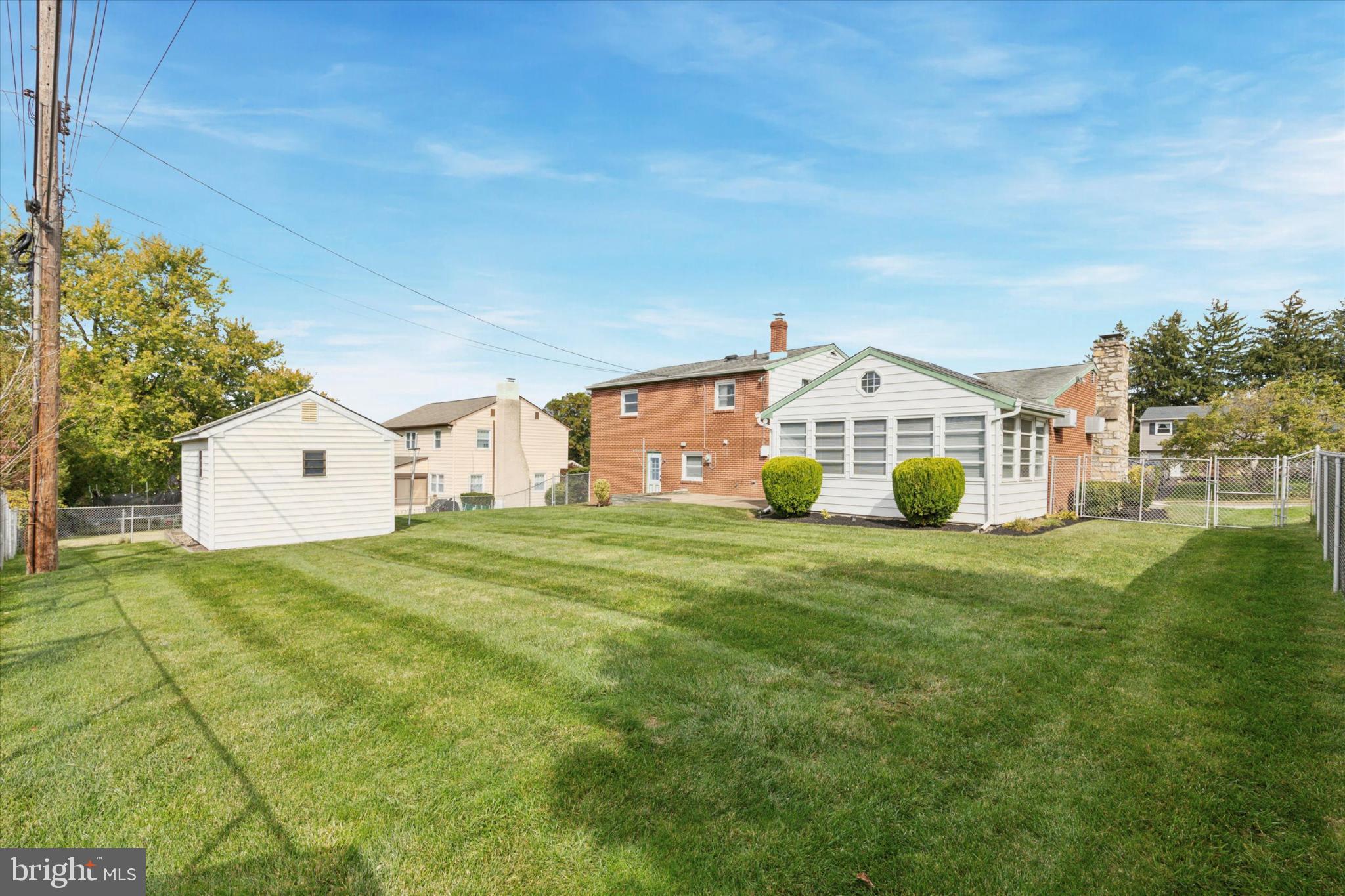 2008 Hemlock Road Jeffersonville, PA 19403 - Photo 2 of 32 a view of a white house that has a big yard and large trees