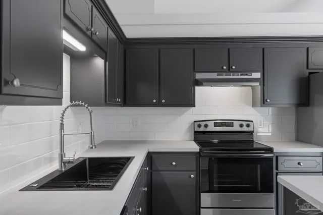 a kitchen with a stove and a sink