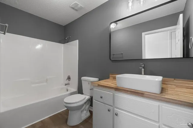 a bathroom with a toilet a sink and bathtub