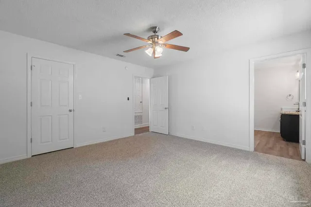 a view of a livingroom with a ceiling fan and window