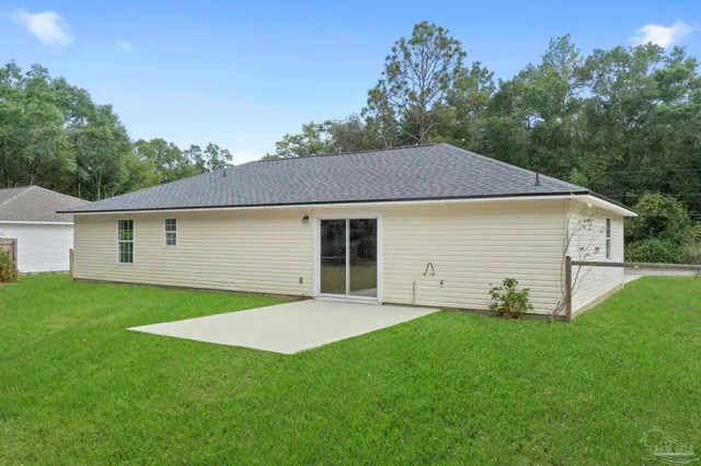a front view of house with a garden