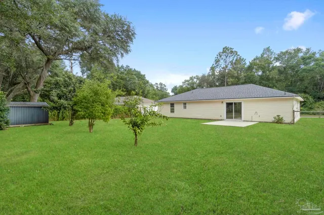 a front view of a house with a garden and yard
