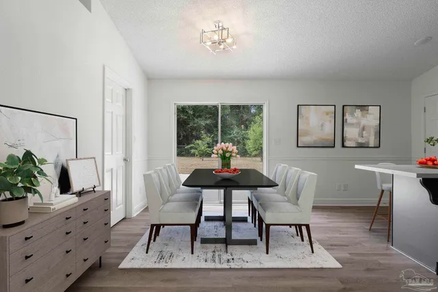 a living room with furniture a potted plant and a table