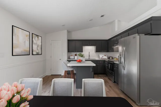 a kitchen with cabinets a sink and appliances
