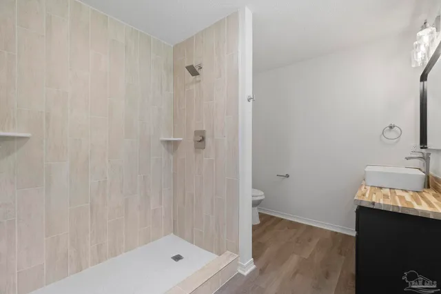 a bathroom with a shower and a sink