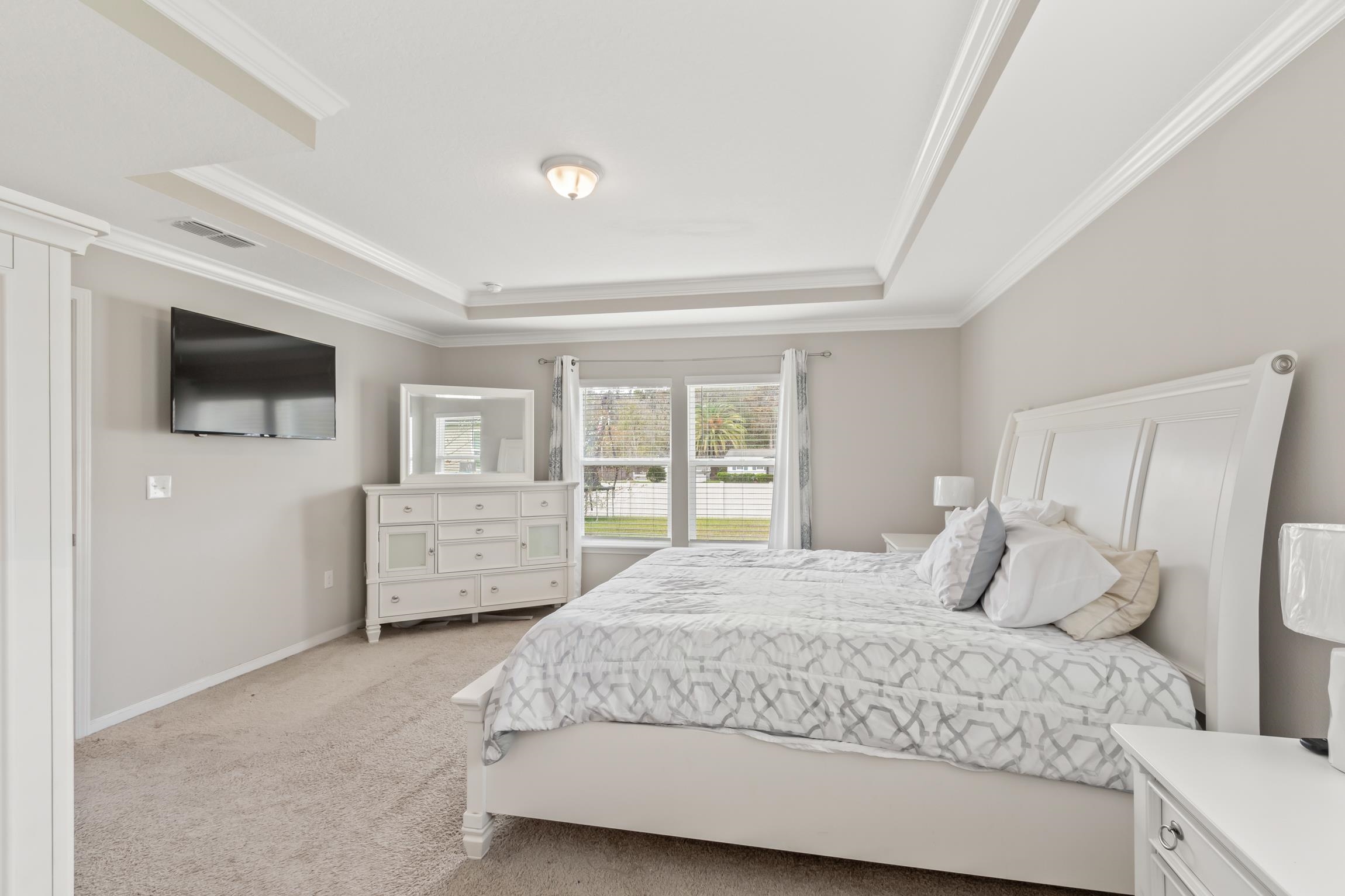 392 South Hamilton Springs Road St. Augustine, FL 32084 - Photo 15 of 29 a bedroom with a bed a tv and wooden floor