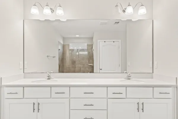 a bathroom with a sink mirror and vanity