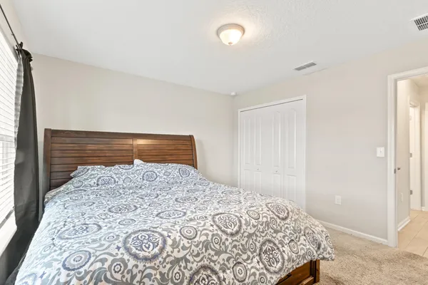 a bedroom with a bed and a dresser