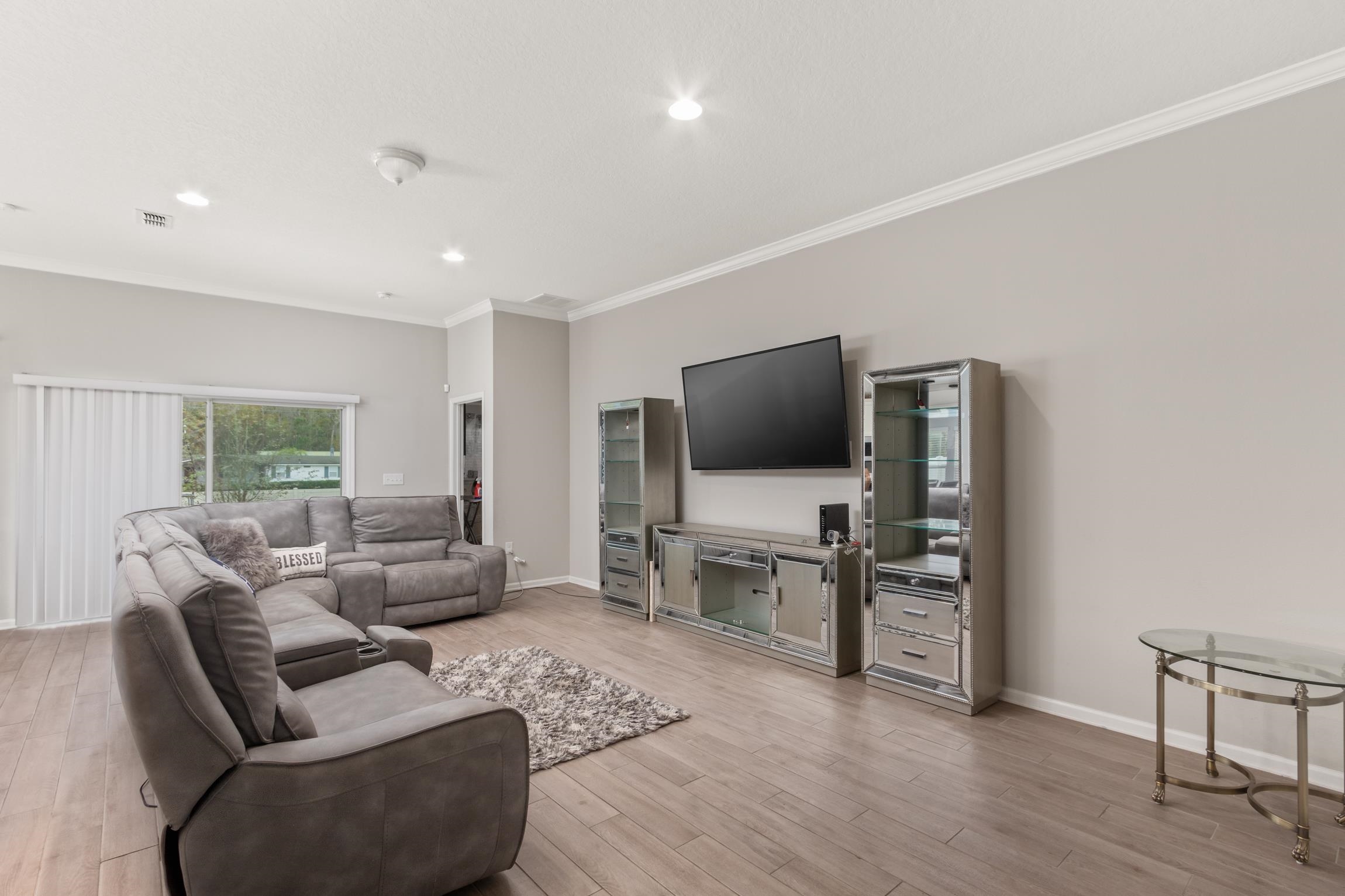 392 South Hamilton Springs Road St. Augustine, FL 32084 - Photo 3 of 29 a living room with furniture and a flat screen tv