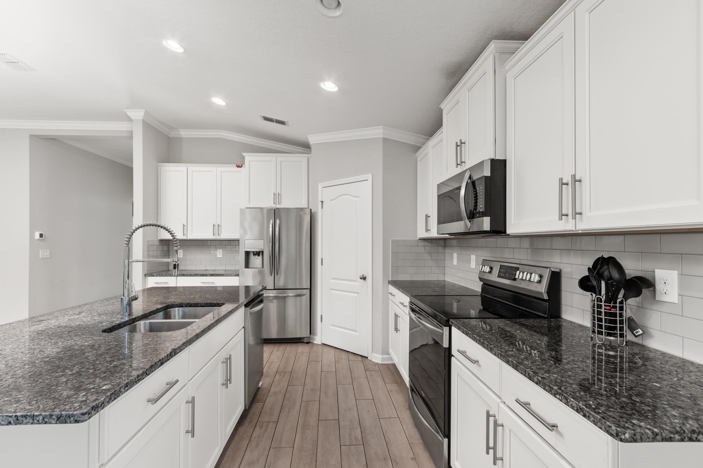 392 South Hamilton Springs Road St. Augustine, FL 32084 - Photo 10 of 29 a kitchen with stainless steel appliances granite countertop a sink stove microwave and refrigerator