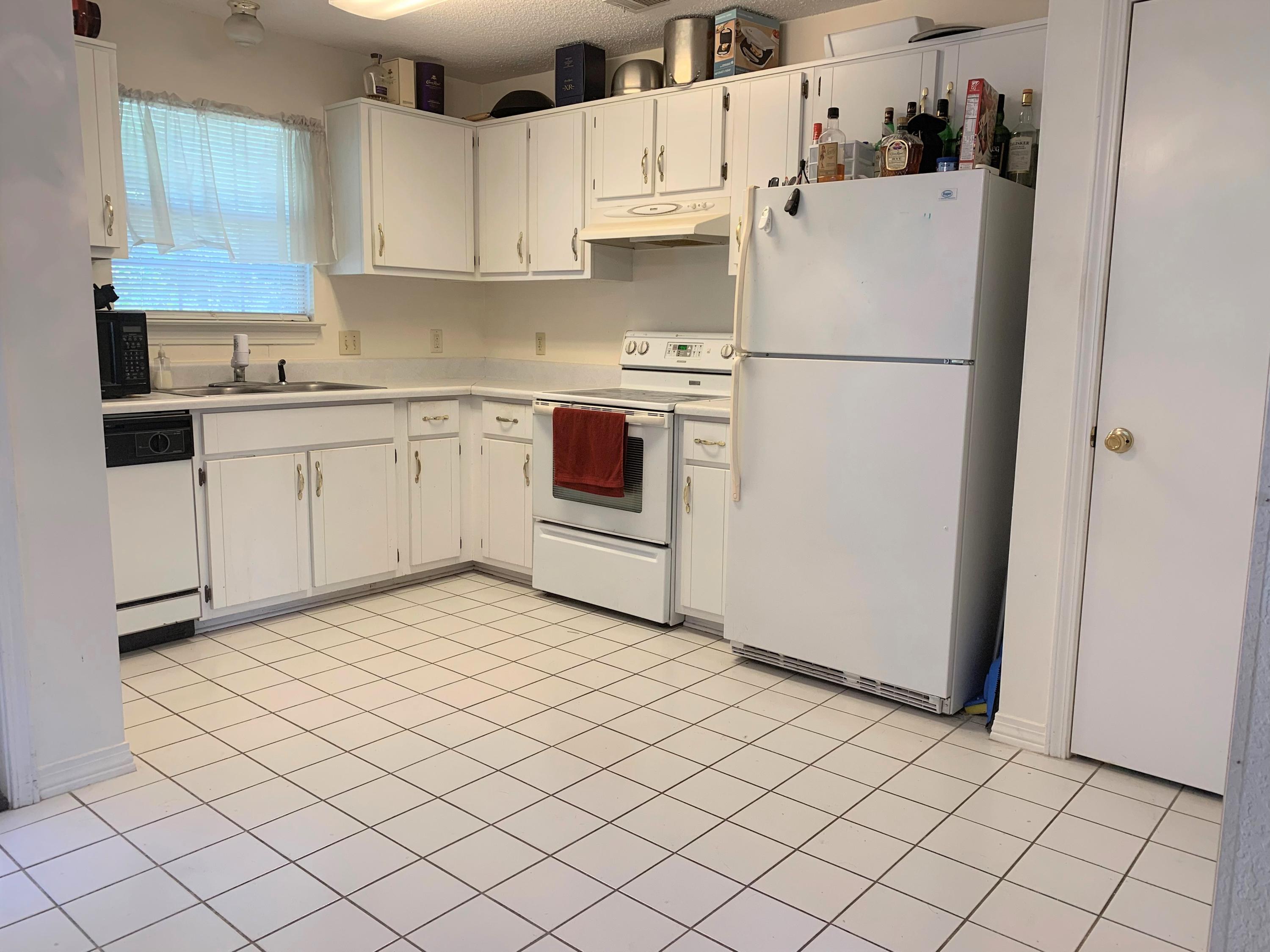 2807 Ping Lane Crestview, FL 32539 - Photo 17 of 28 a kitchen with a refrigerator sink stove and cabinets