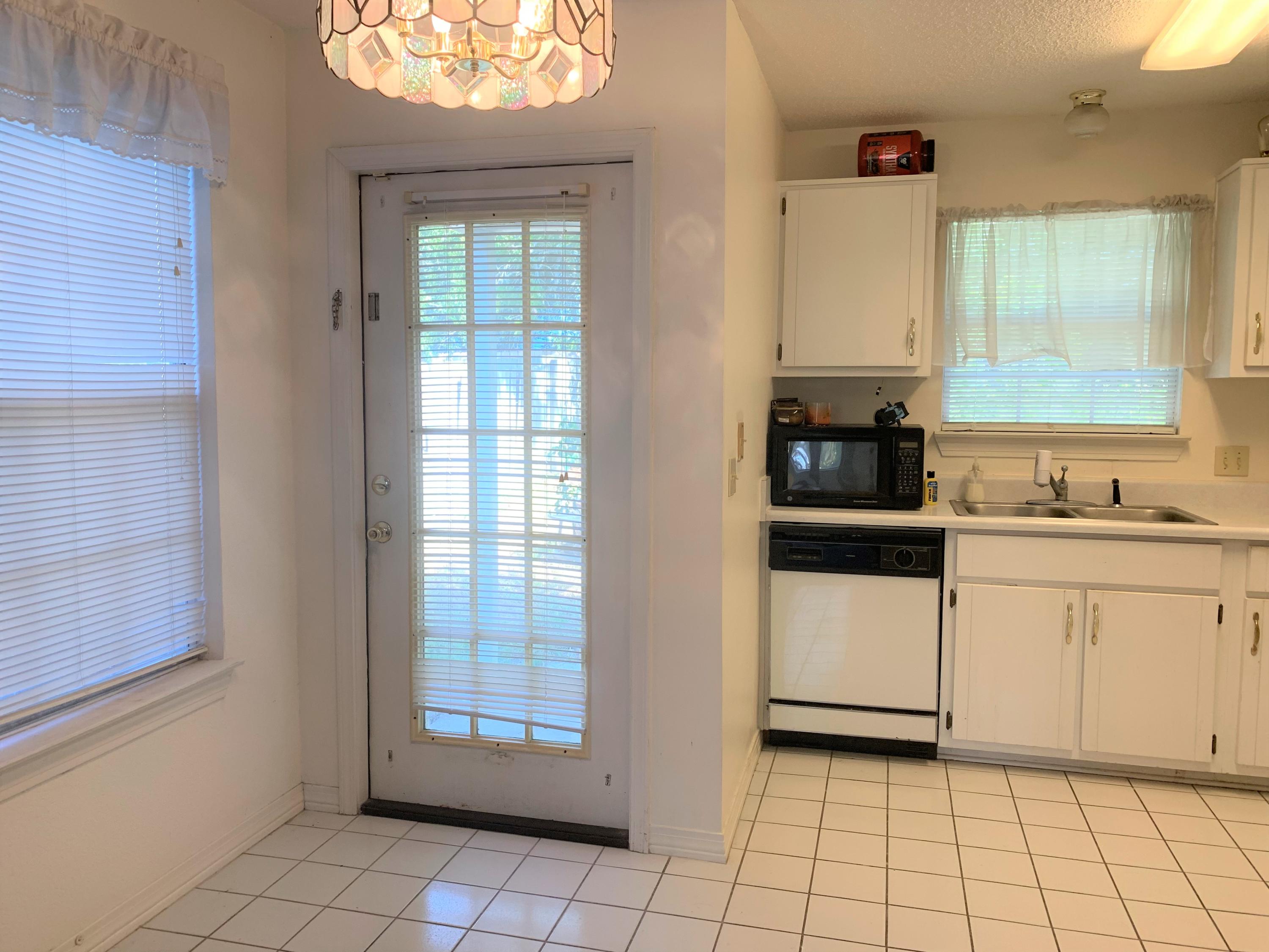 2807 Ping Lane Crestview, FL 32539 - Photo 18 of 28 a kitchen with a stove a sink and a refrigerator