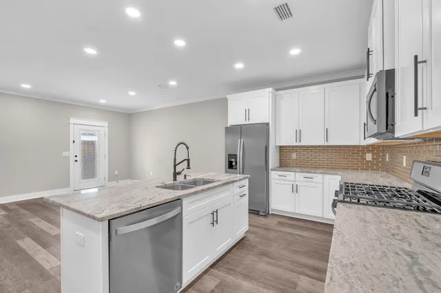 a kitchen with a sink stove and refrigerator