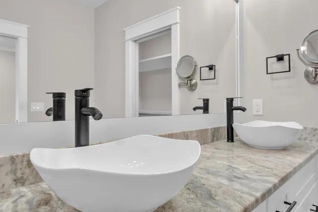 a bathroom with a bathtub and mirror