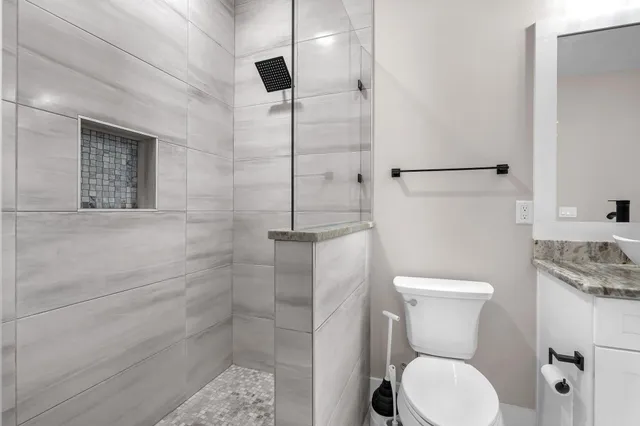 a bathroom with a toilet a sink and shower