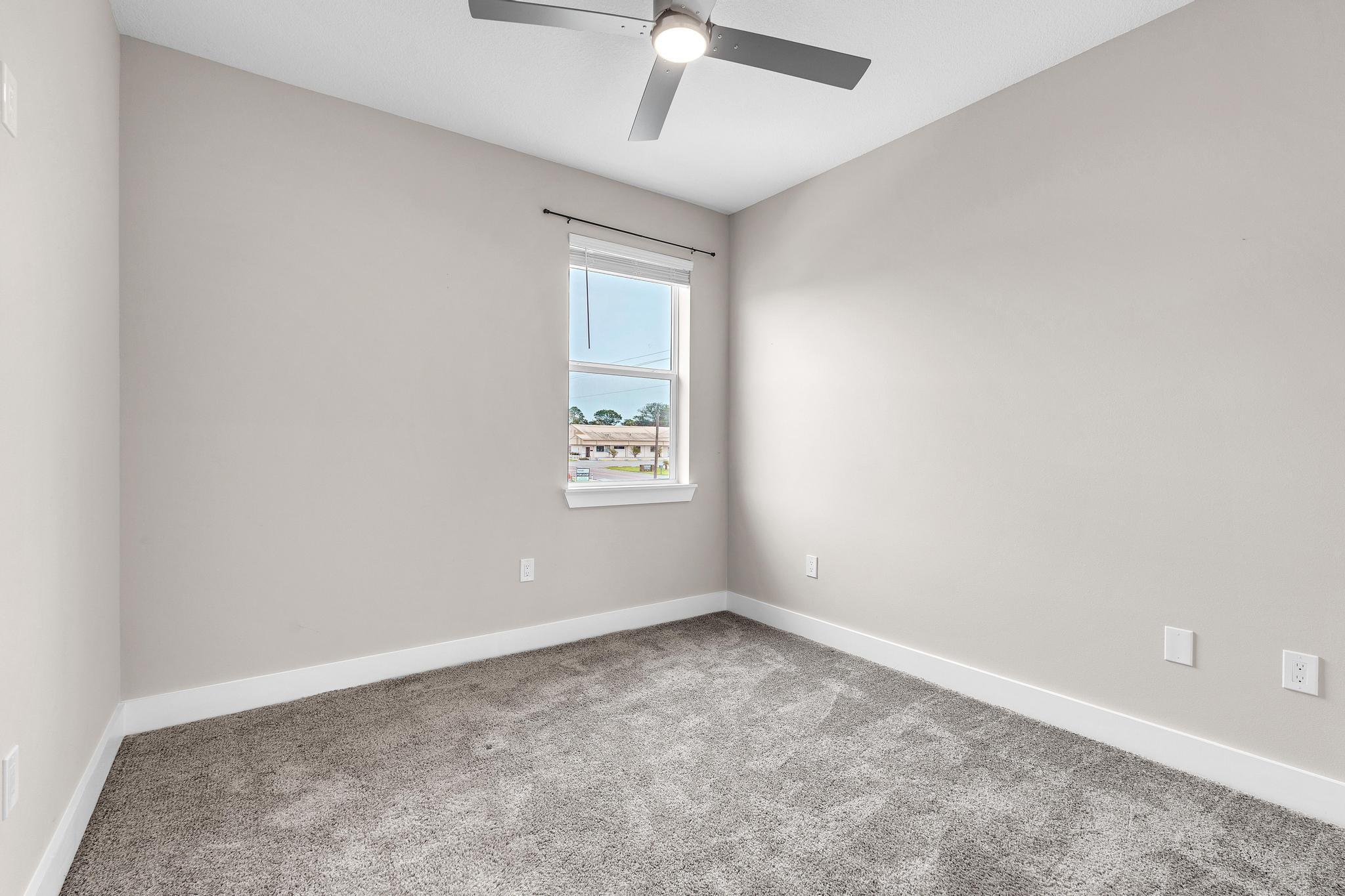 2 Praiseworthy Drive Valparaiso, FL 32580 - Photo 30 of 36 an empty room with a ceiling fan and window