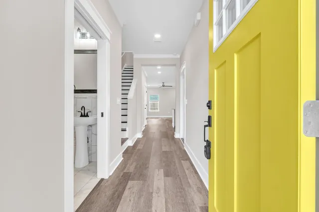 a view of a hallway with wooden floor
