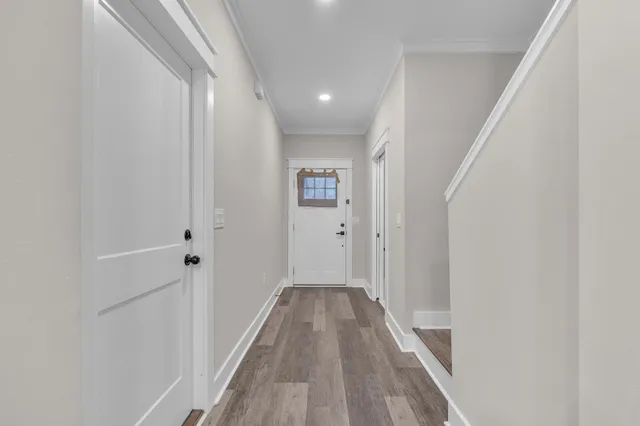 a view of a hallway with wooden floor