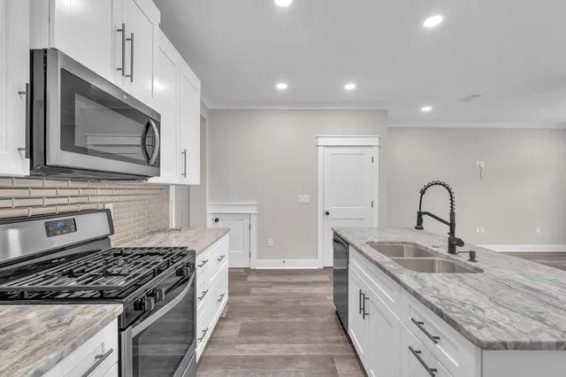 a kitchen with granite countertop stainless steel appliances and sink