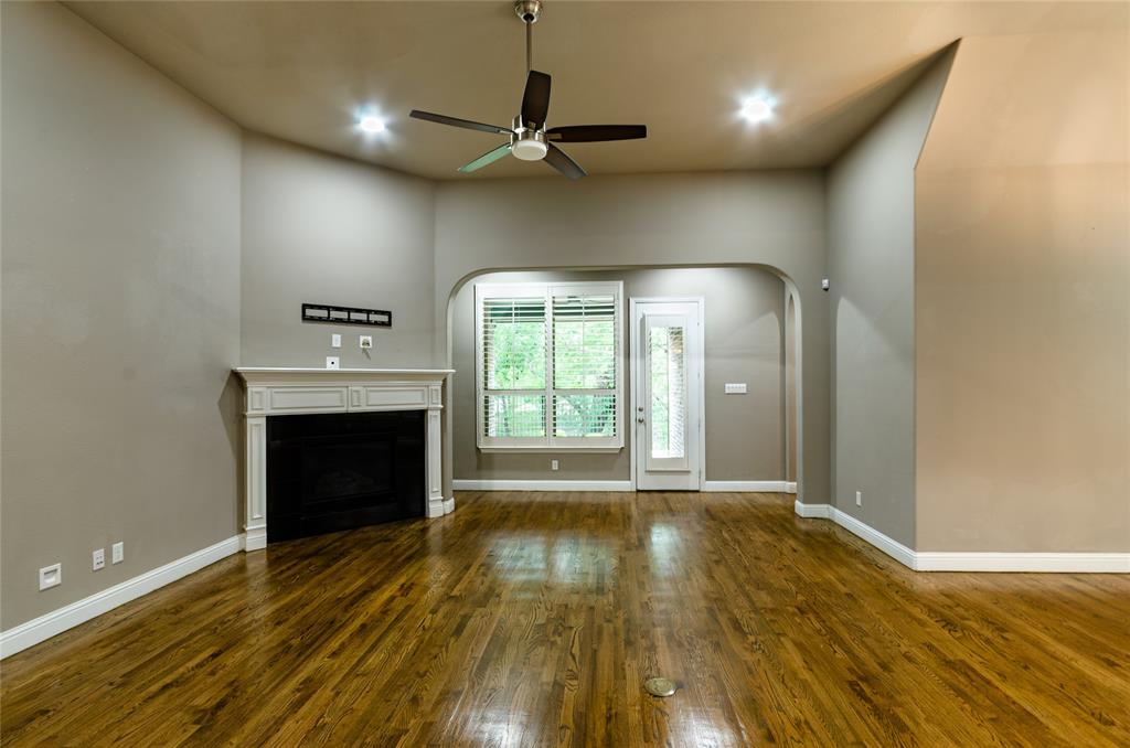 1863 Audubon Pond Way Allen, TX 75013 - Photo 14 of 40 an empty room with wooden floor fireplace and windows