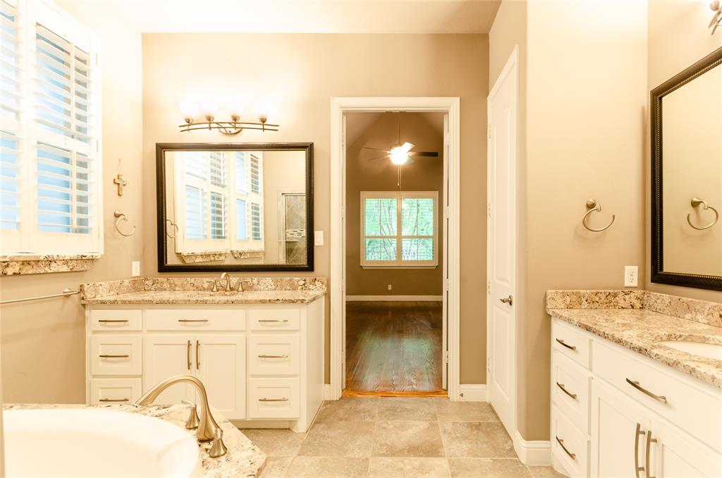 1863 Audubon Pond Way Allen, TX 75013 - Photo 22 of 40 a bathroom with a granite countertop sink and a mirror